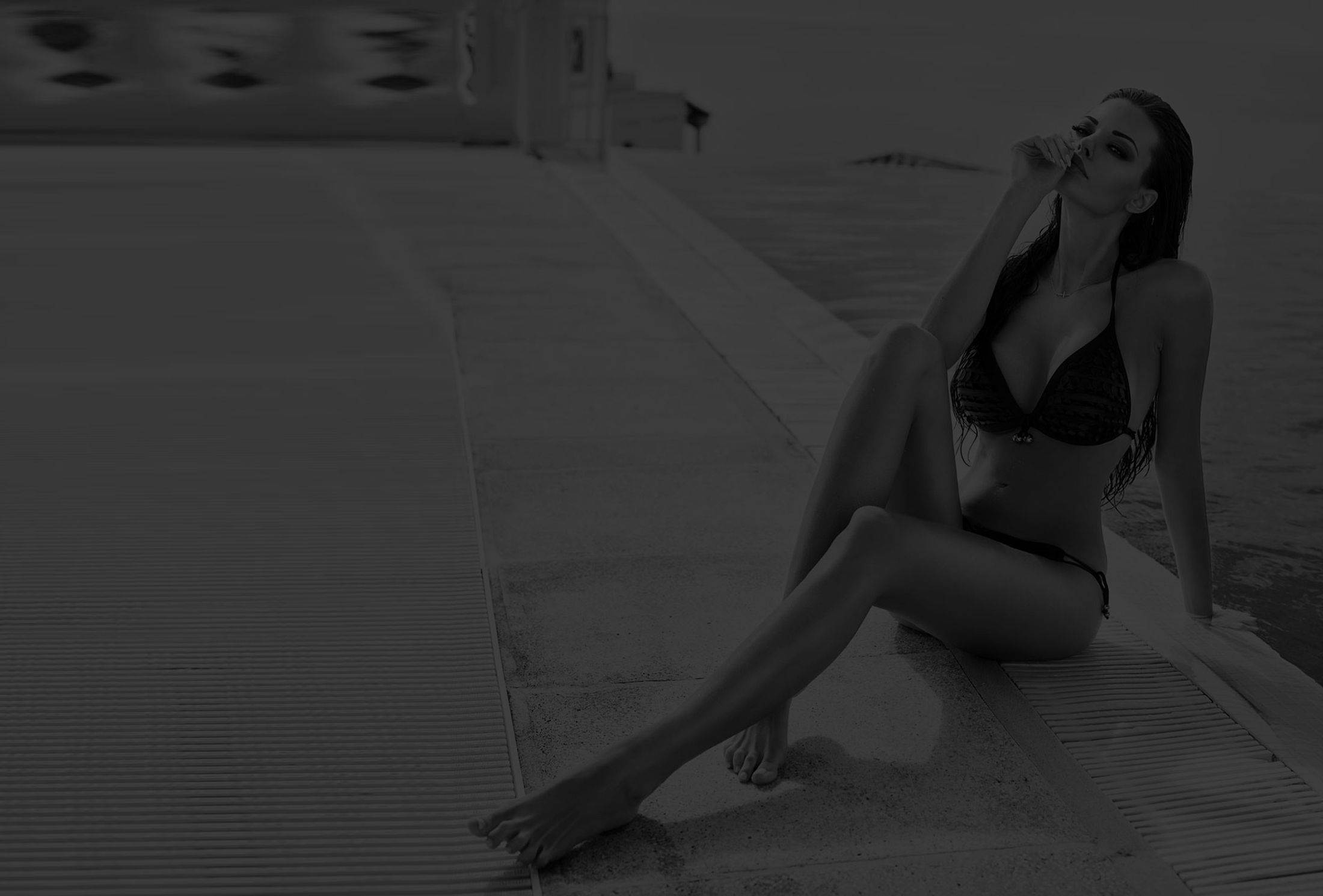 Woman relaxing by the pool in swimwear.