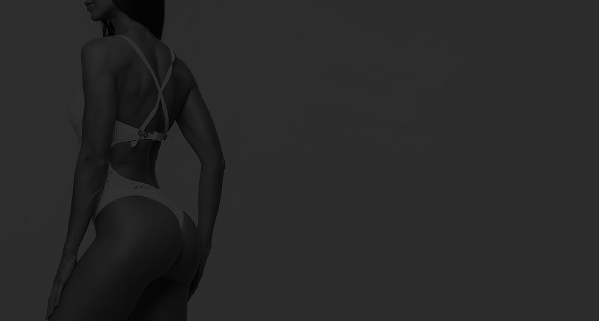 Model posing in a stylish swimsuit from behind.