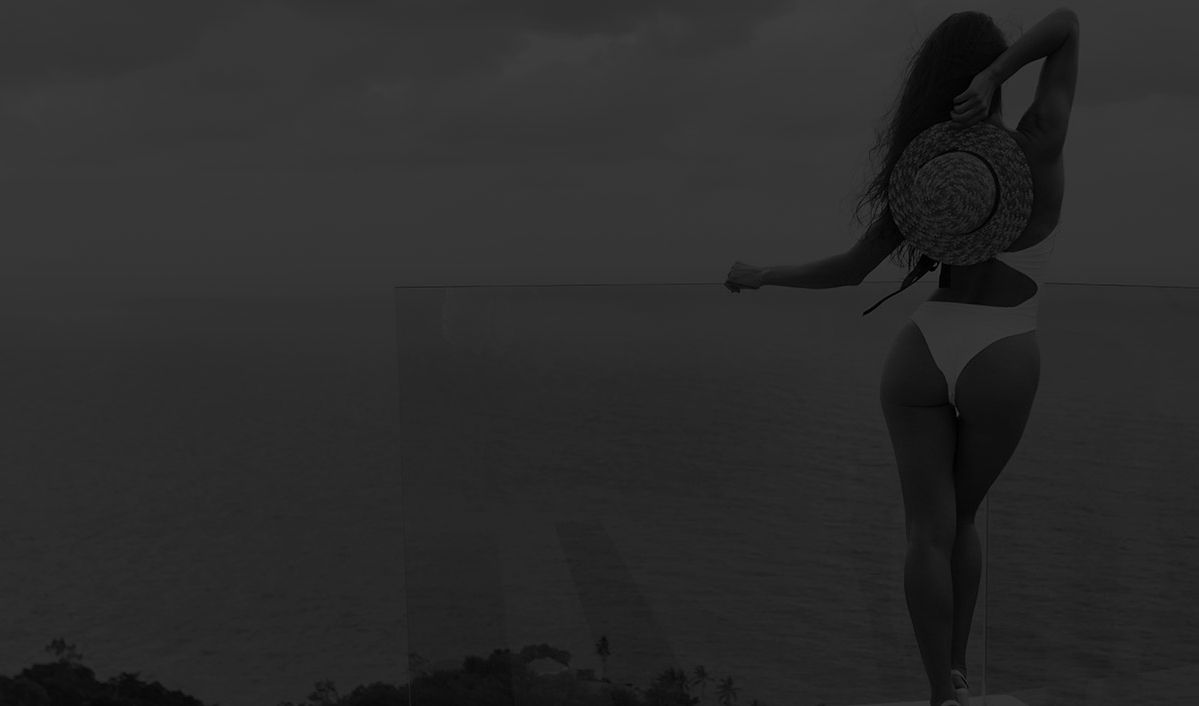 Woman in bikini overlooking the ocean view.