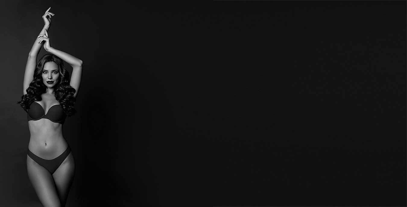 Model posing elegantly against a dark background.