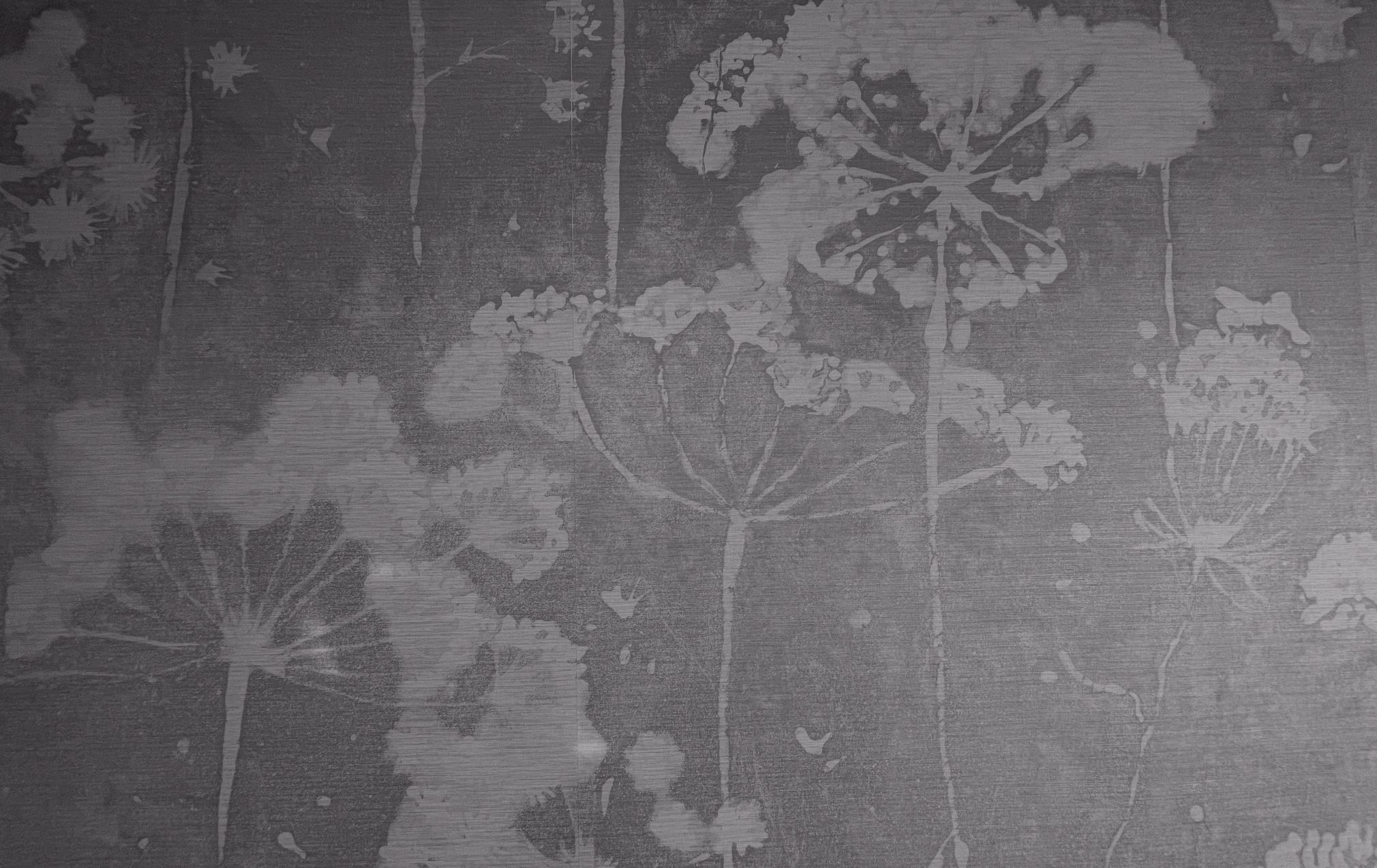 Gray floral pattern on textured background.