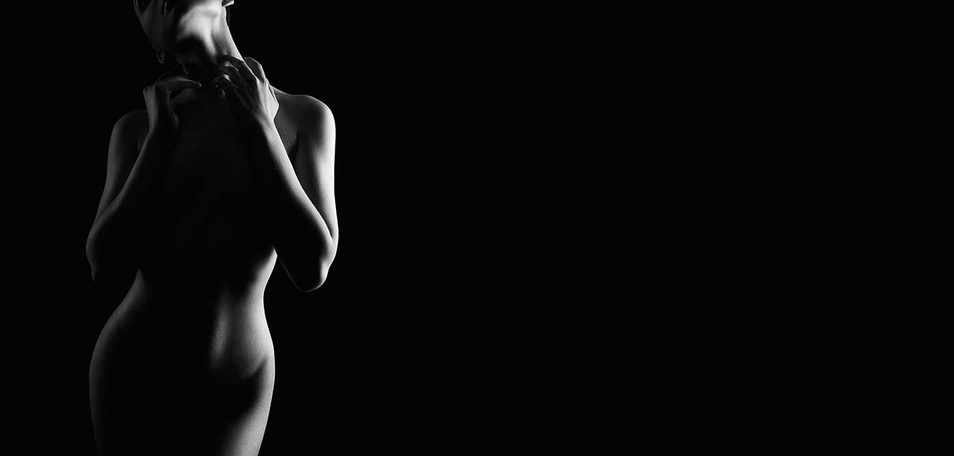 Silhouette of a graceful figure against black background.
