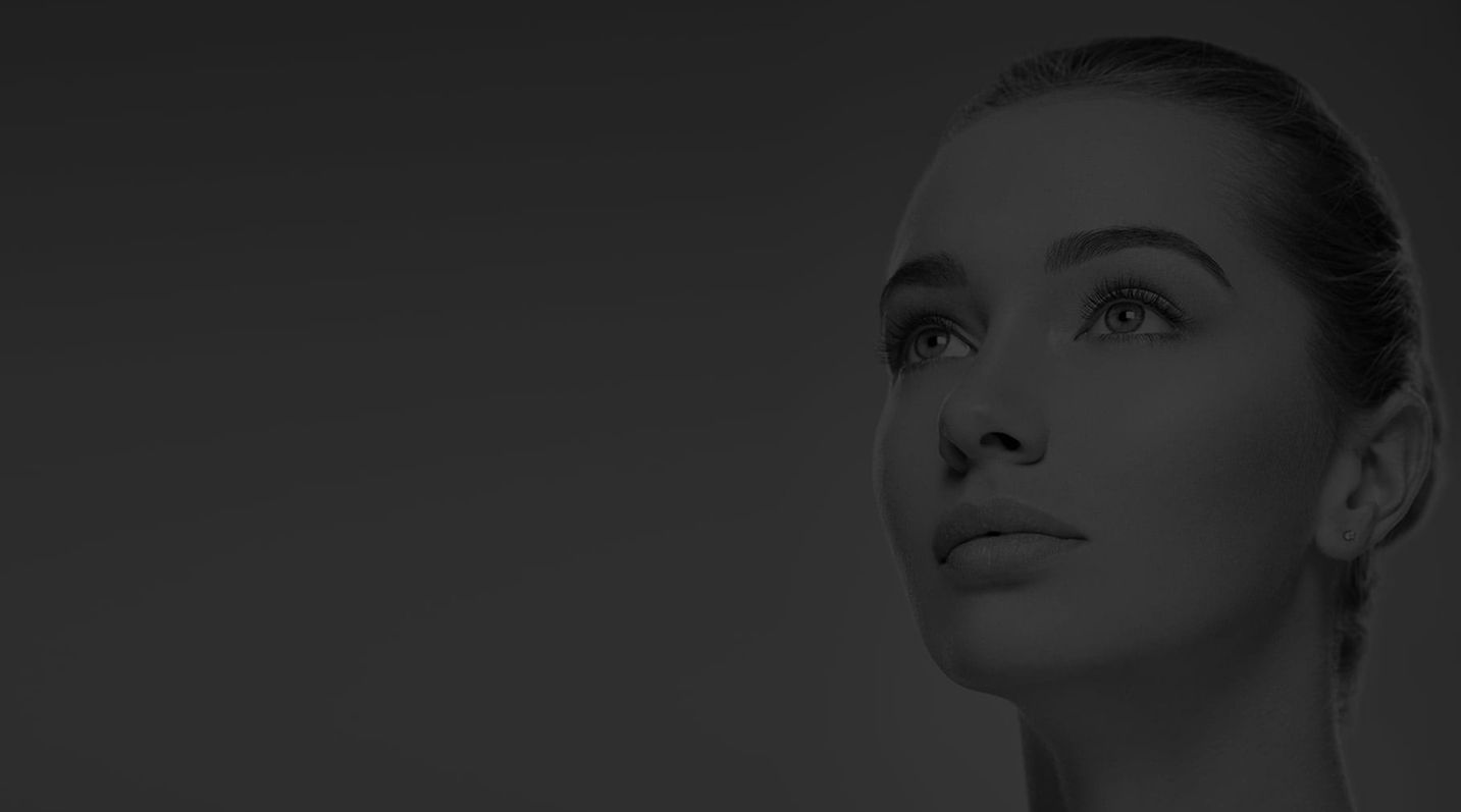 Woman gazing upwards with a neutral expression.