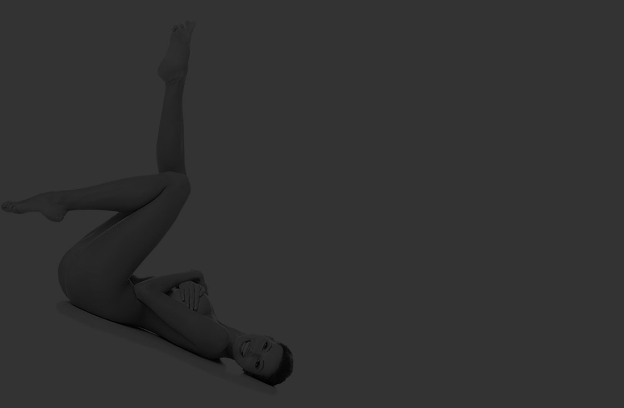 Smiling person posing creatively on the floor.