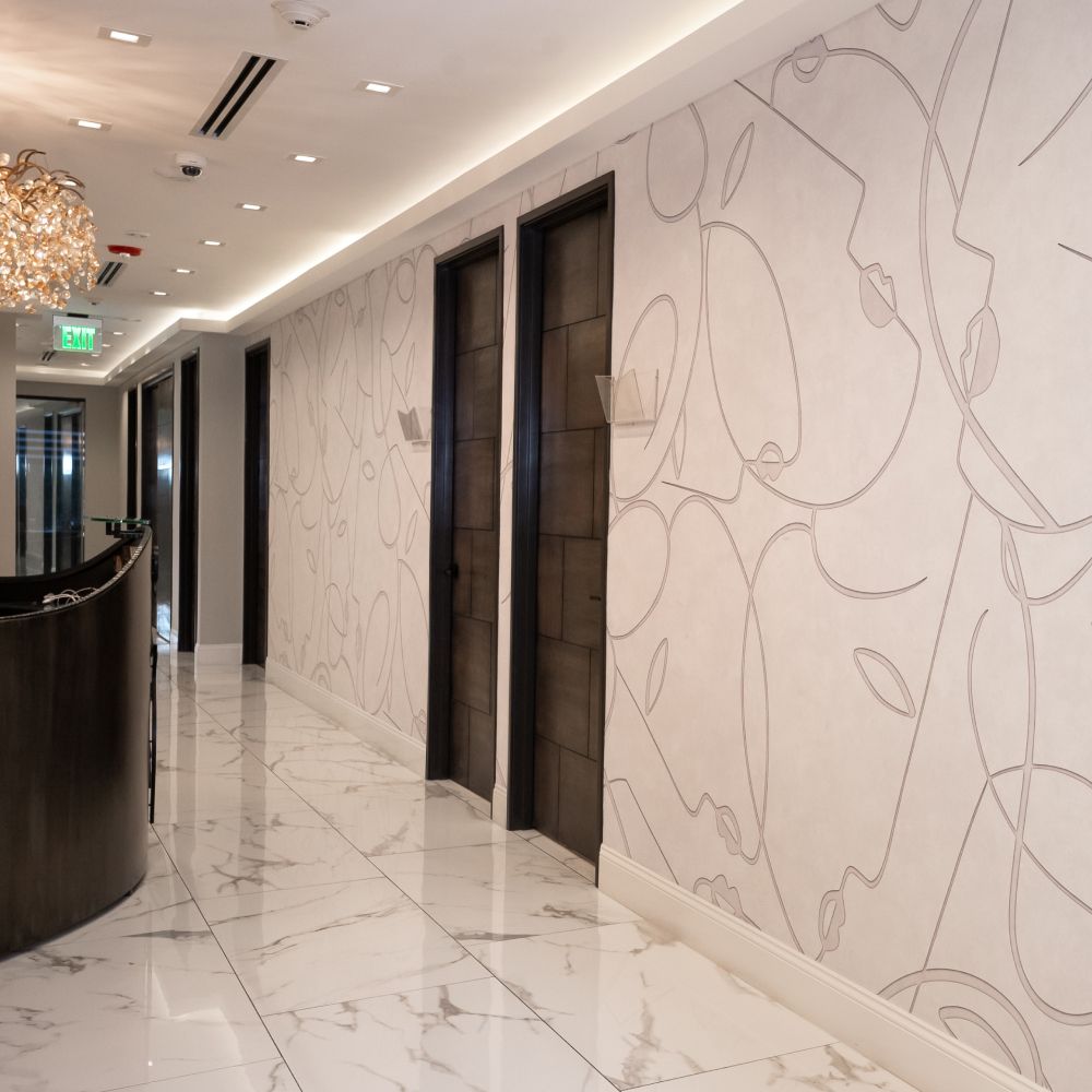 Elegant hallway with decorative wall and doors.
