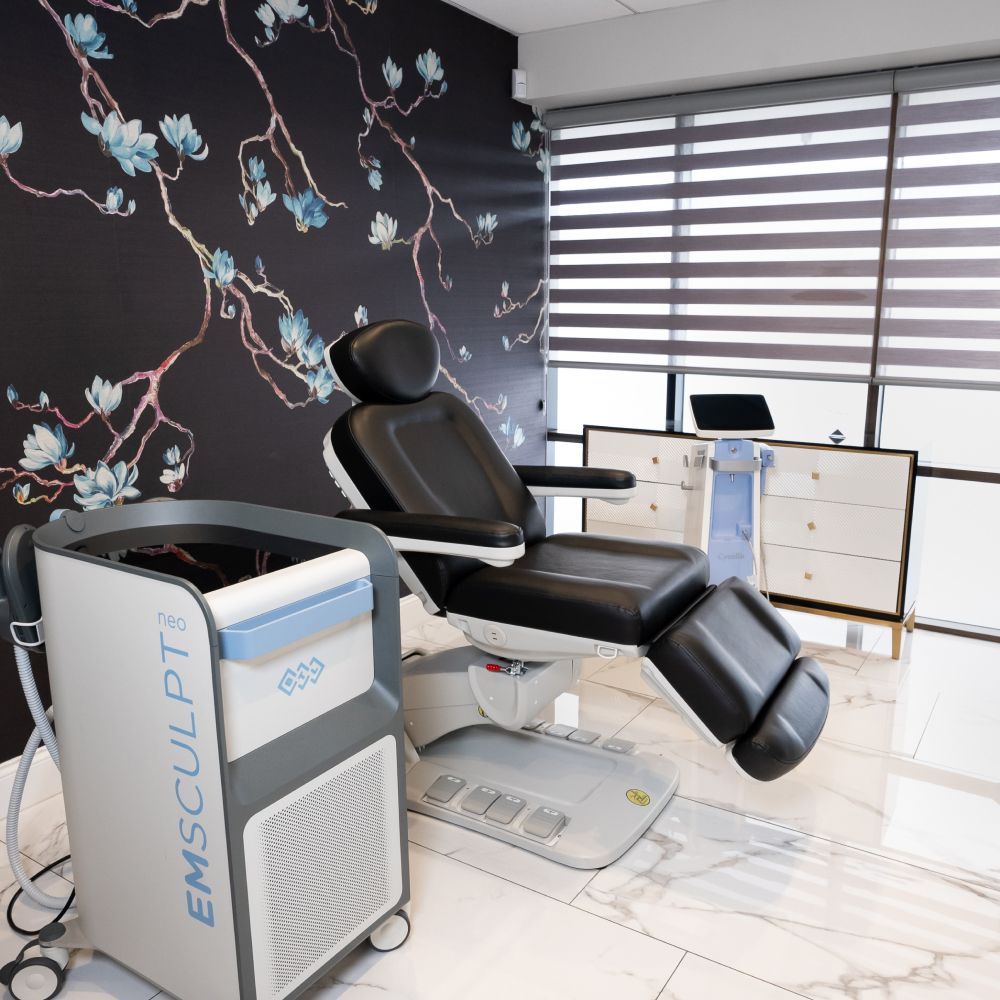 Modern aesthetic treatment room with EMSCULPT equipment.