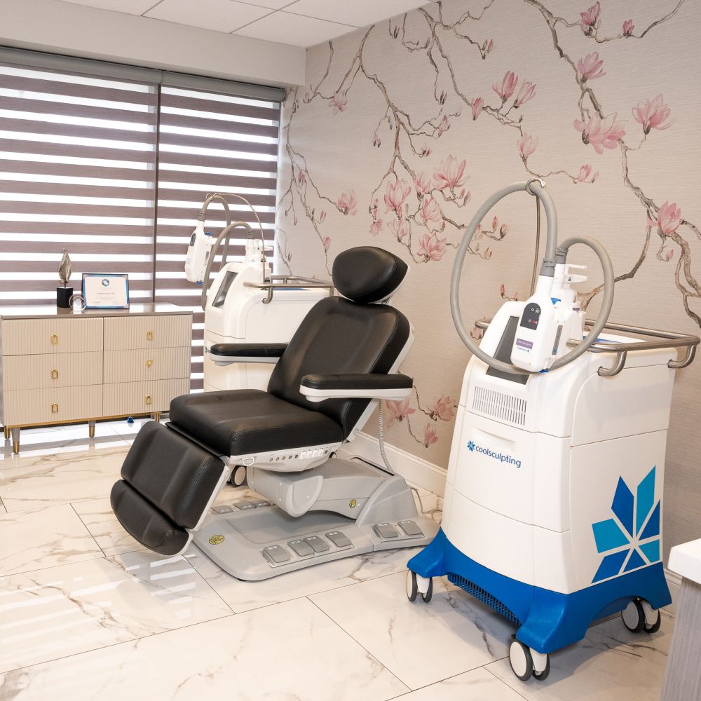 Medical aesthetic treatment room with equipment.
