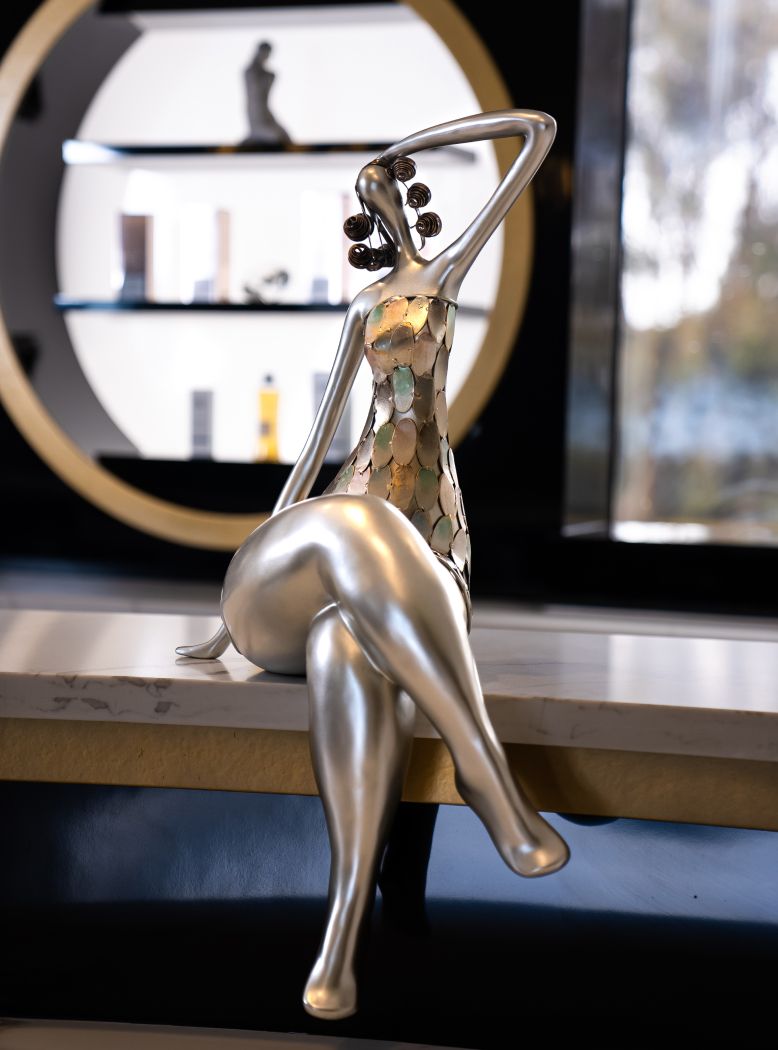 Stylish silver figurine on a tabletop display.