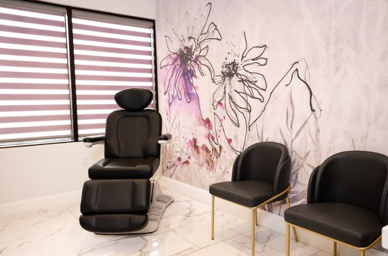 Modern aesthetic treatment room with floral decor.