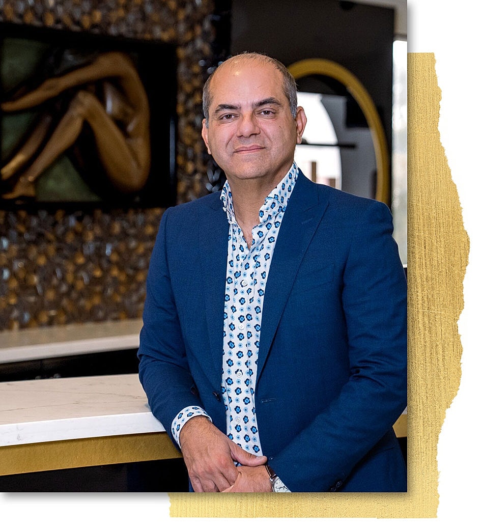 Person in blue suit smiles at the camera.