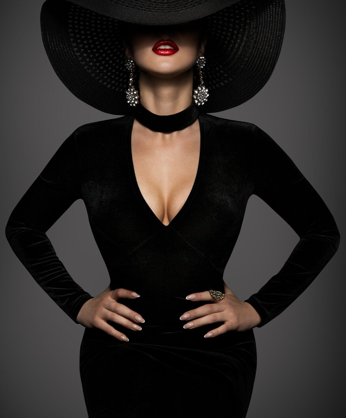 Elegant woman in black dress and wide hat.