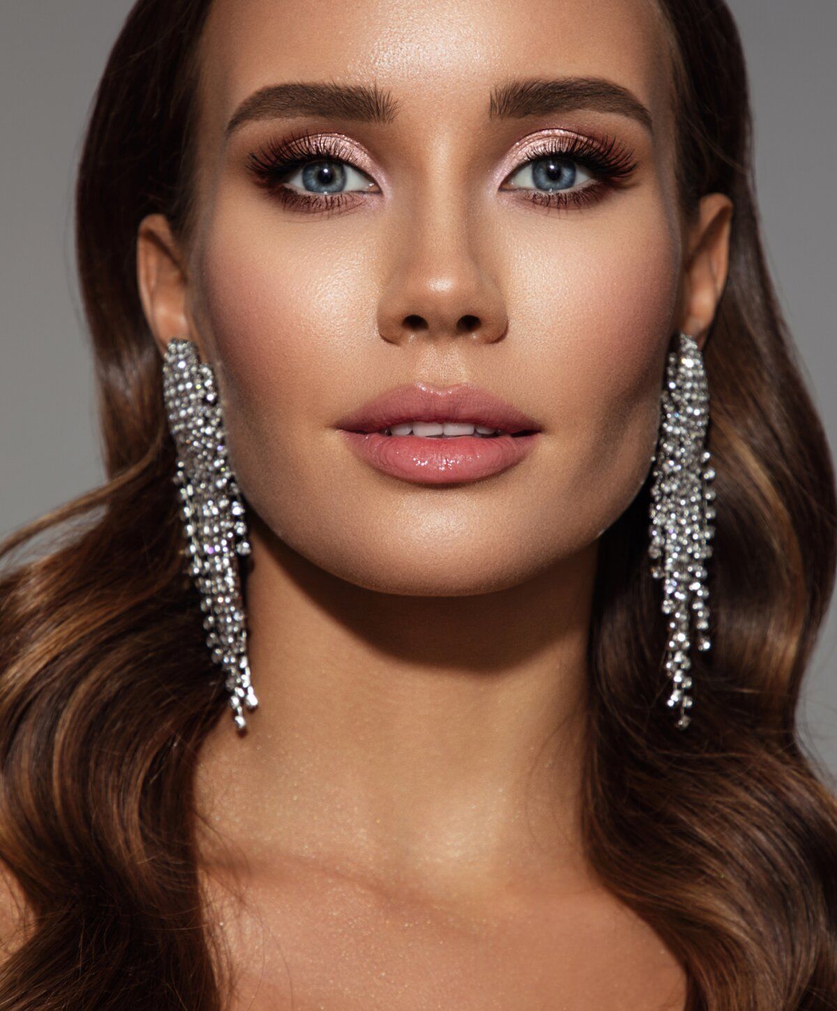 Woman with elegant makeup and sparkling earrings.