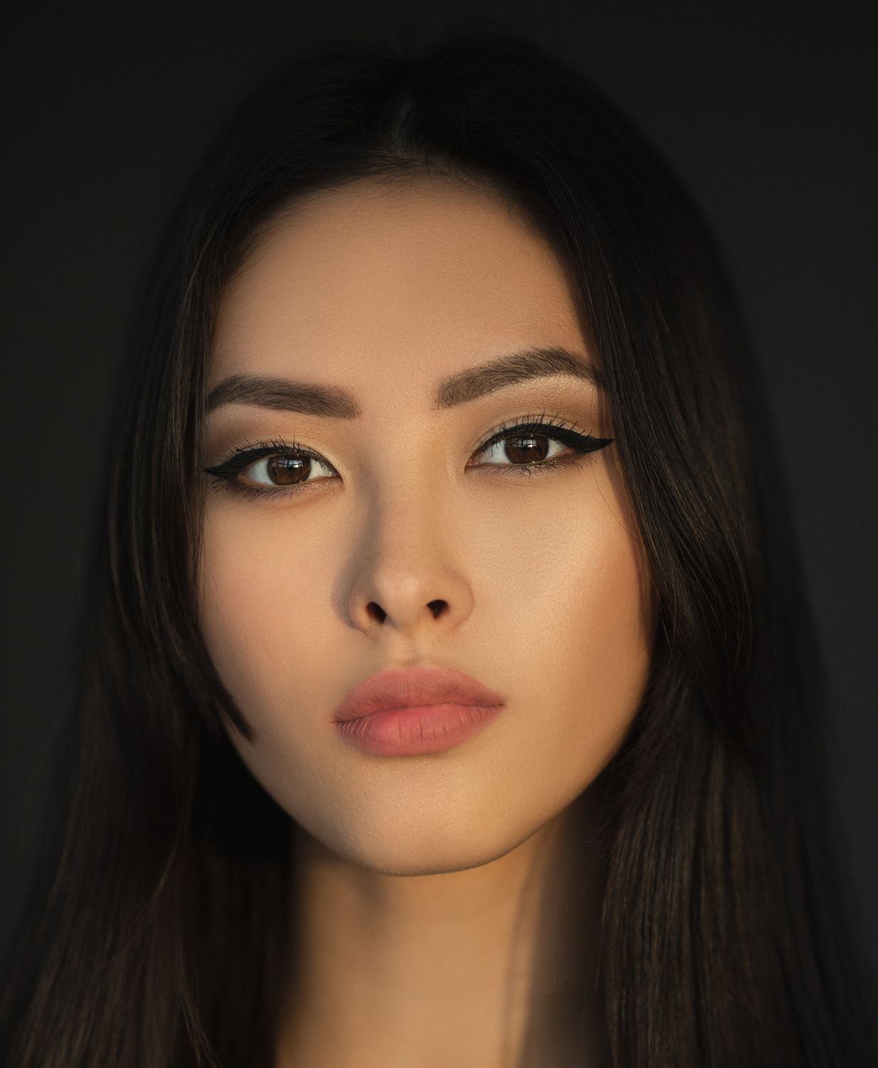 Model in stylish black lace outfit posing elegantly.