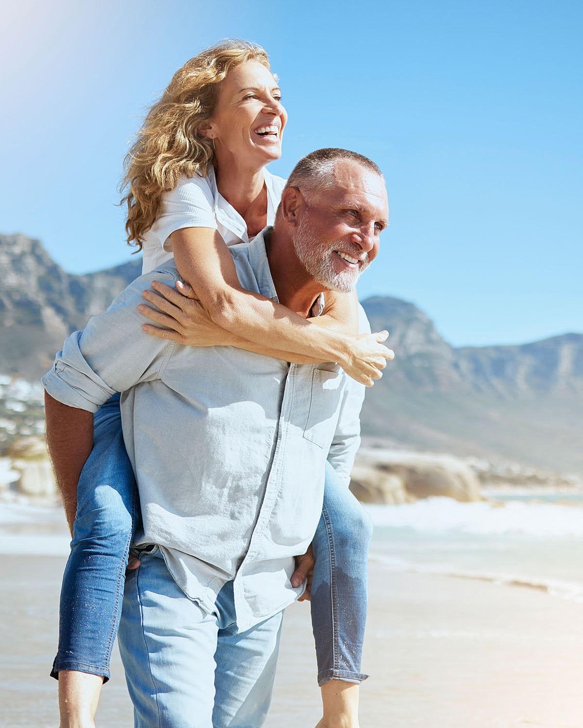 Happy couple enjoying a beach day together.