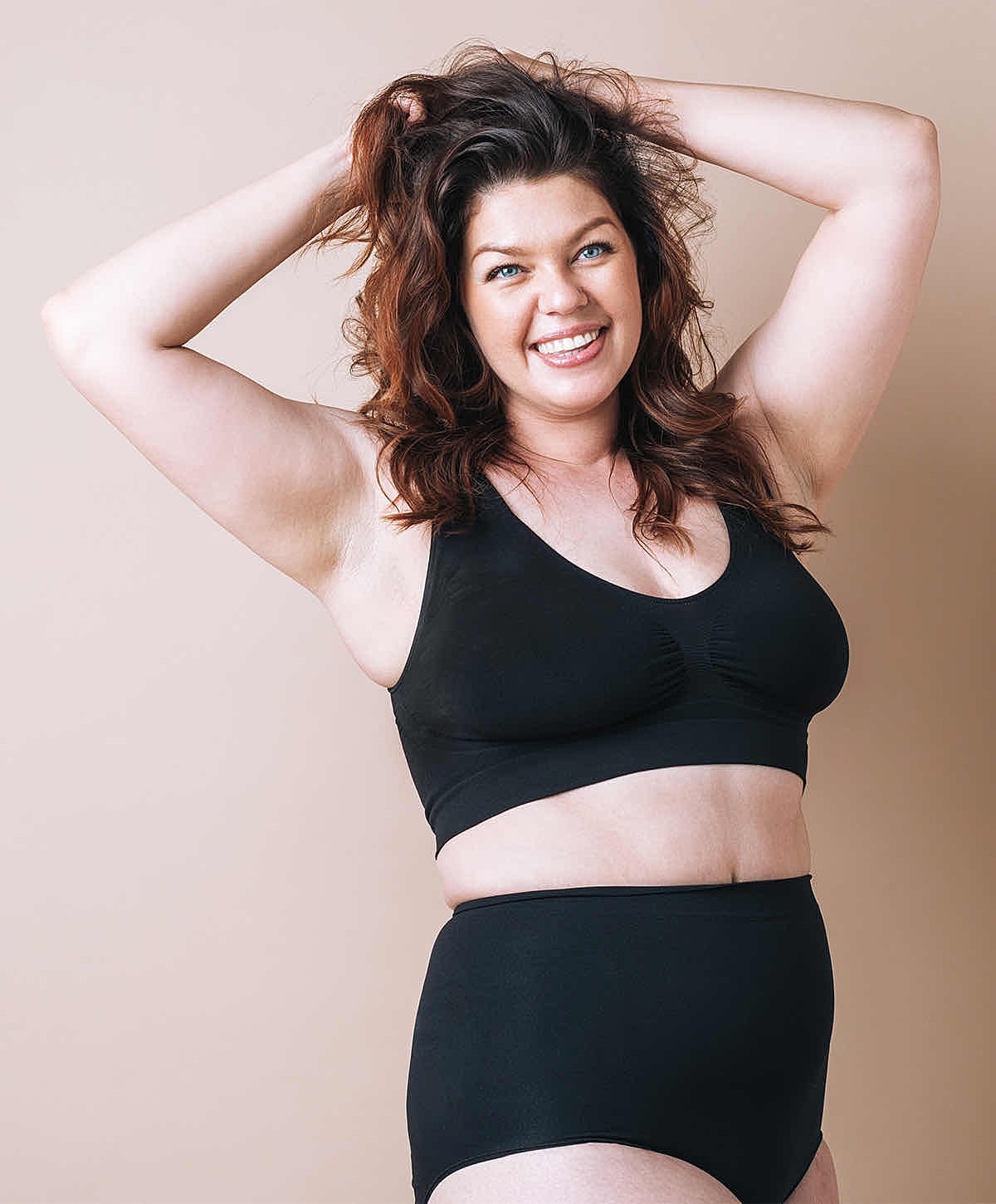 Model posing in a sequined bikini by water.