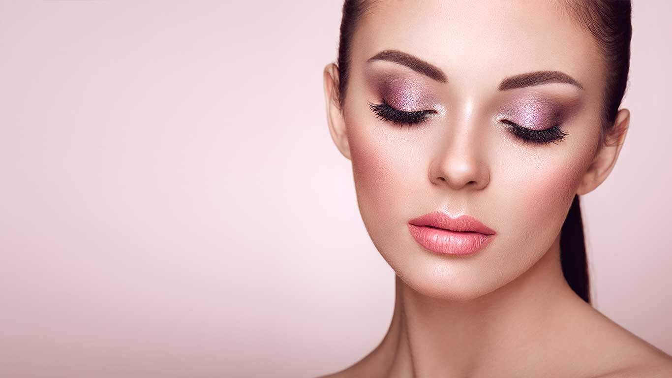 Woman with elegant makeup and soft expression.