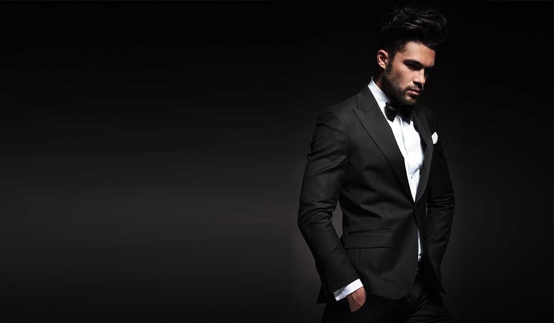 Man in tuxedo against a dark background.