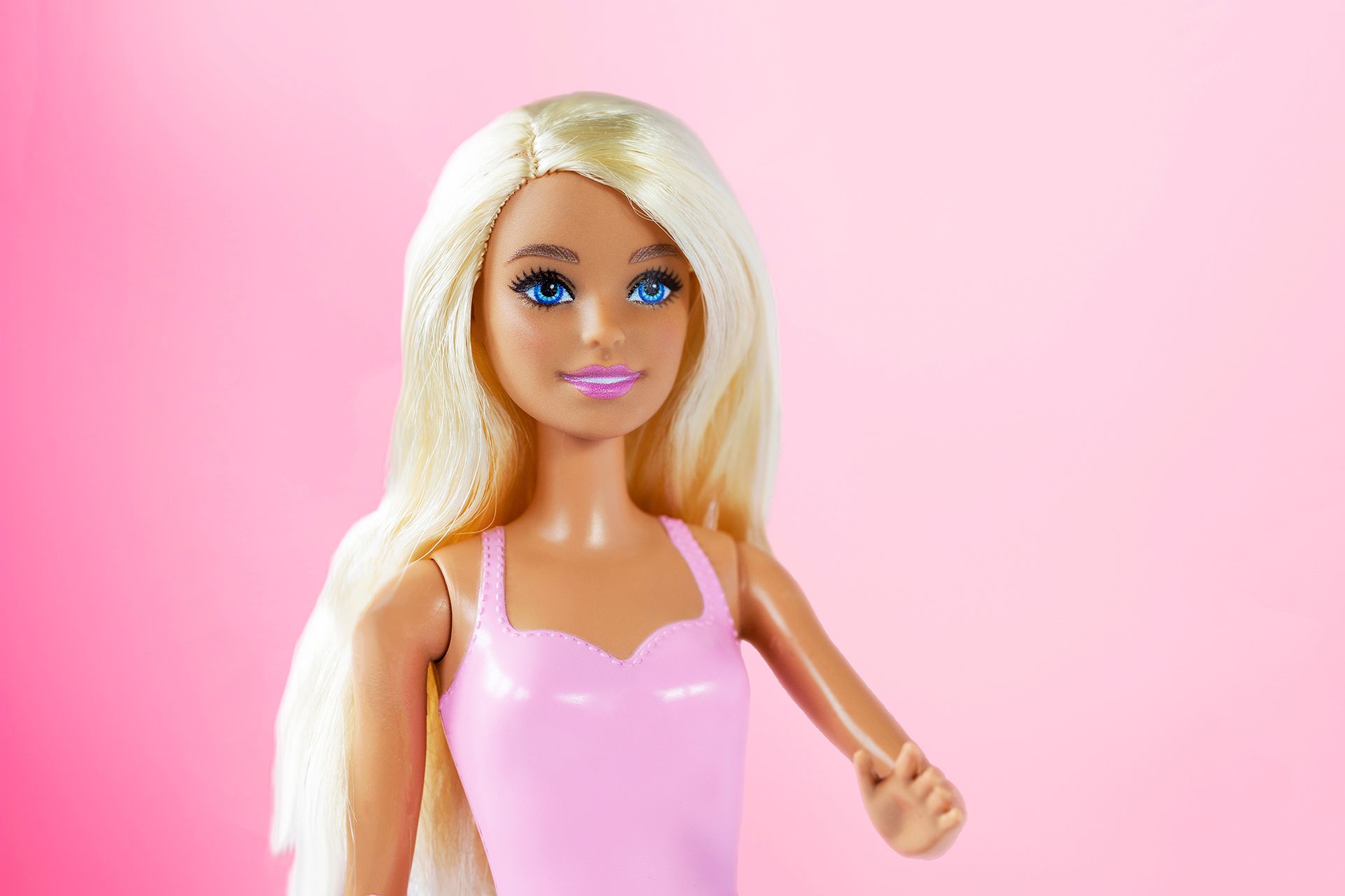 Fashion doll with long blonde hair and pink swimsuit.