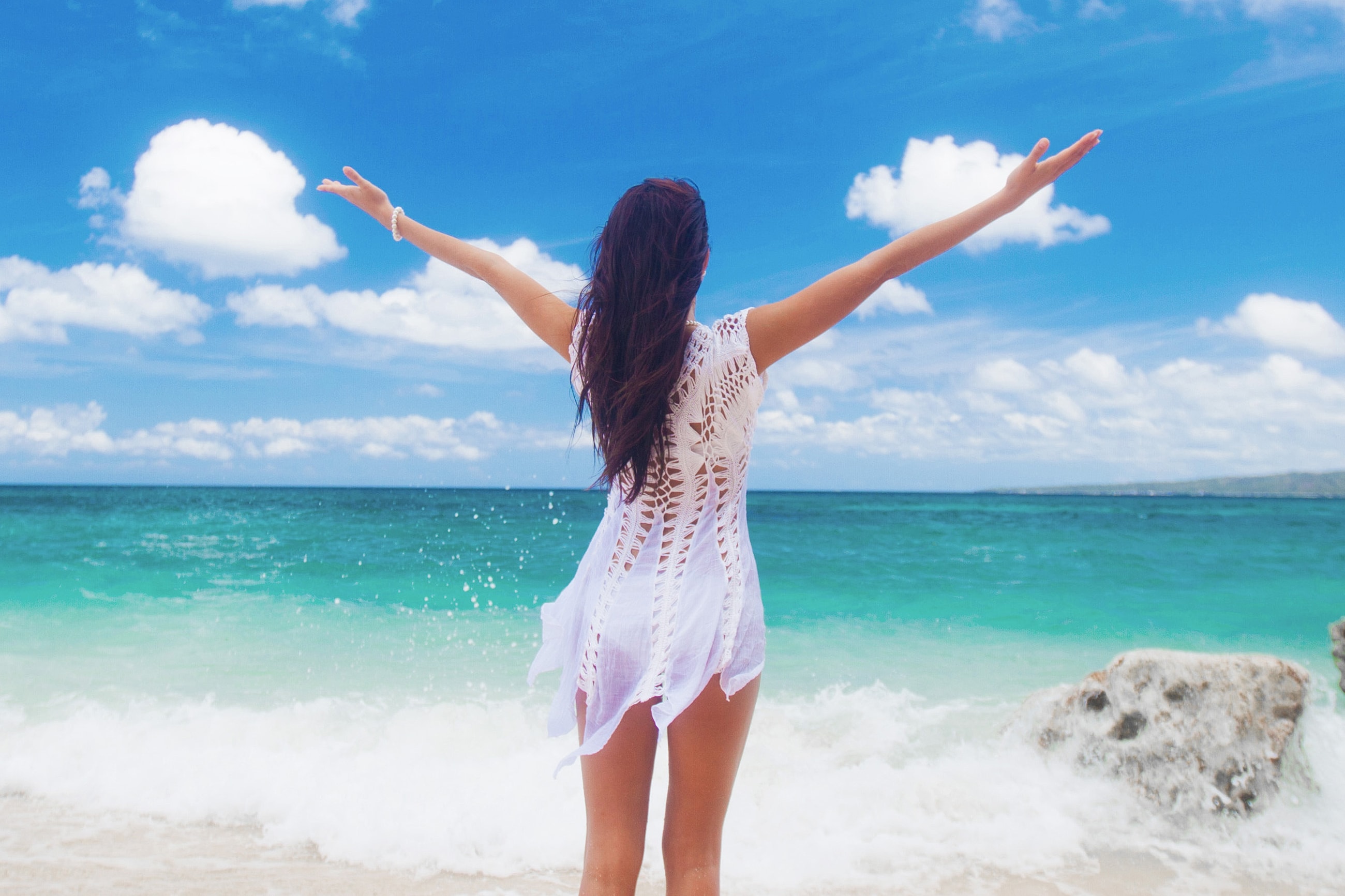 Person enjoying a sunny day at the beach.