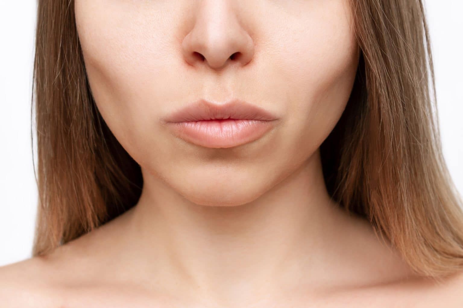Close-up of woman's lips and chin area.
