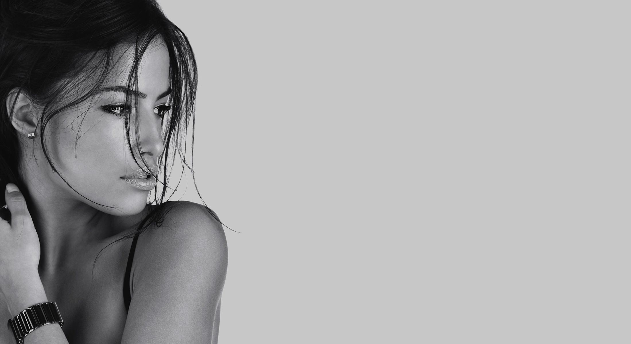 Attractive hispanic female combing hair with hand