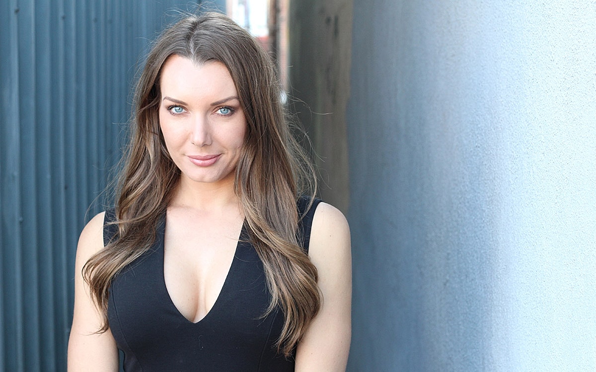 Woman with long hair in a black dress.