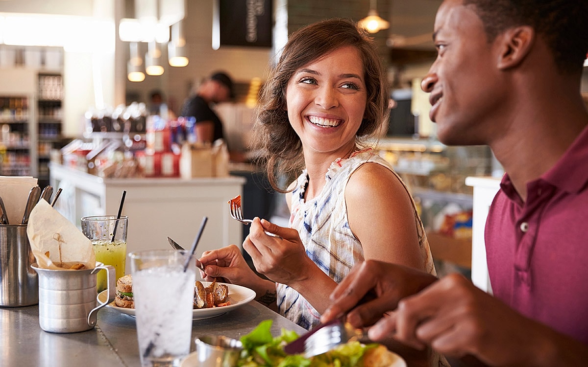 Smiling couple enjoying a meal together.
