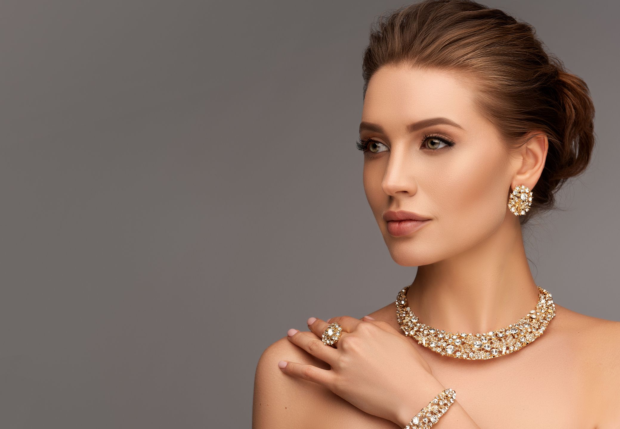 Model showcasing elegant jewelry in soft lighting.