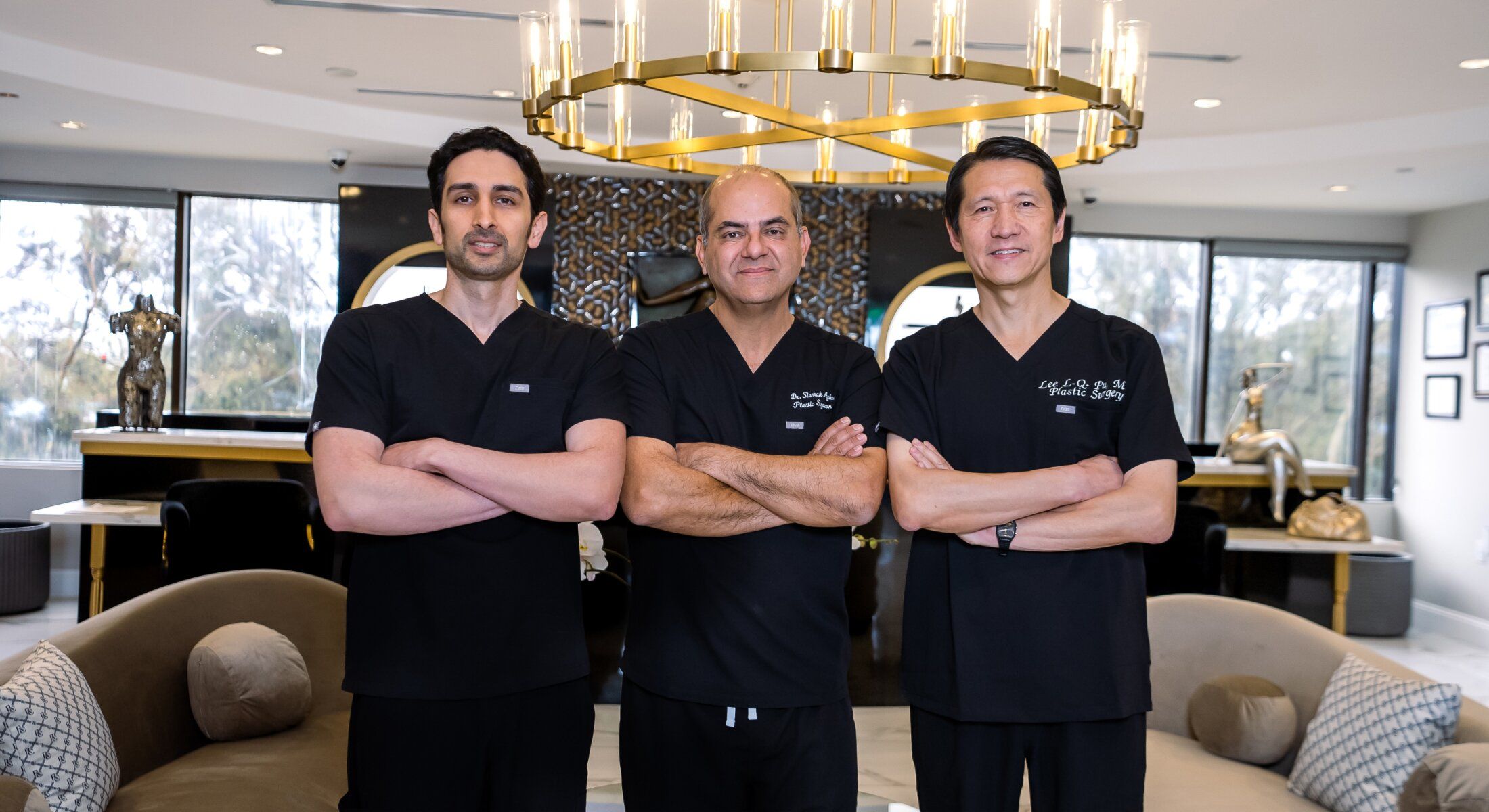 Three doctors posing in a stylish modern office.