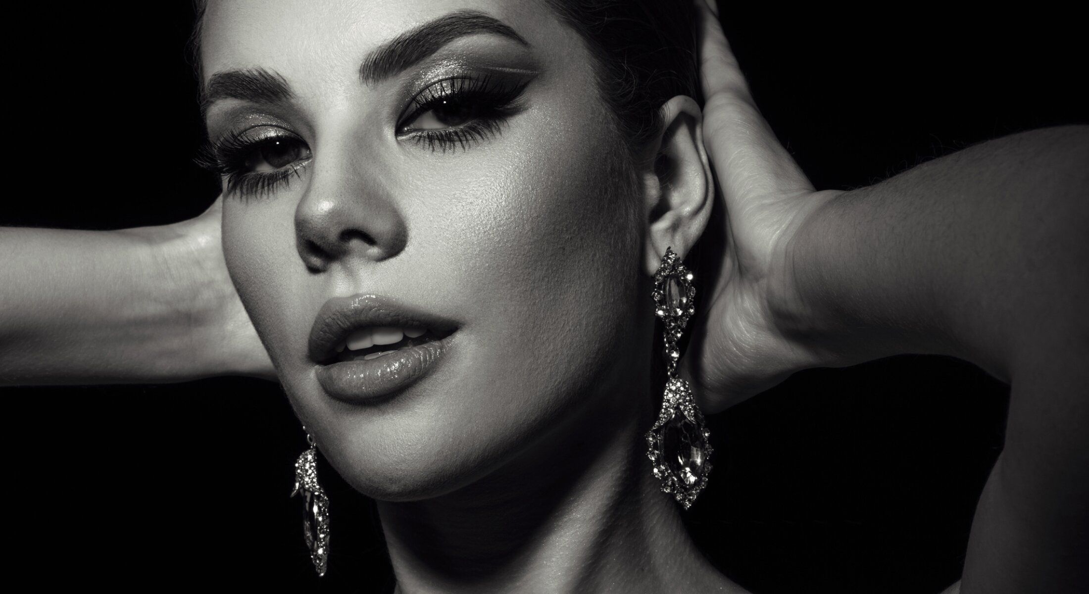 Elegant woman with earrings in black and white.