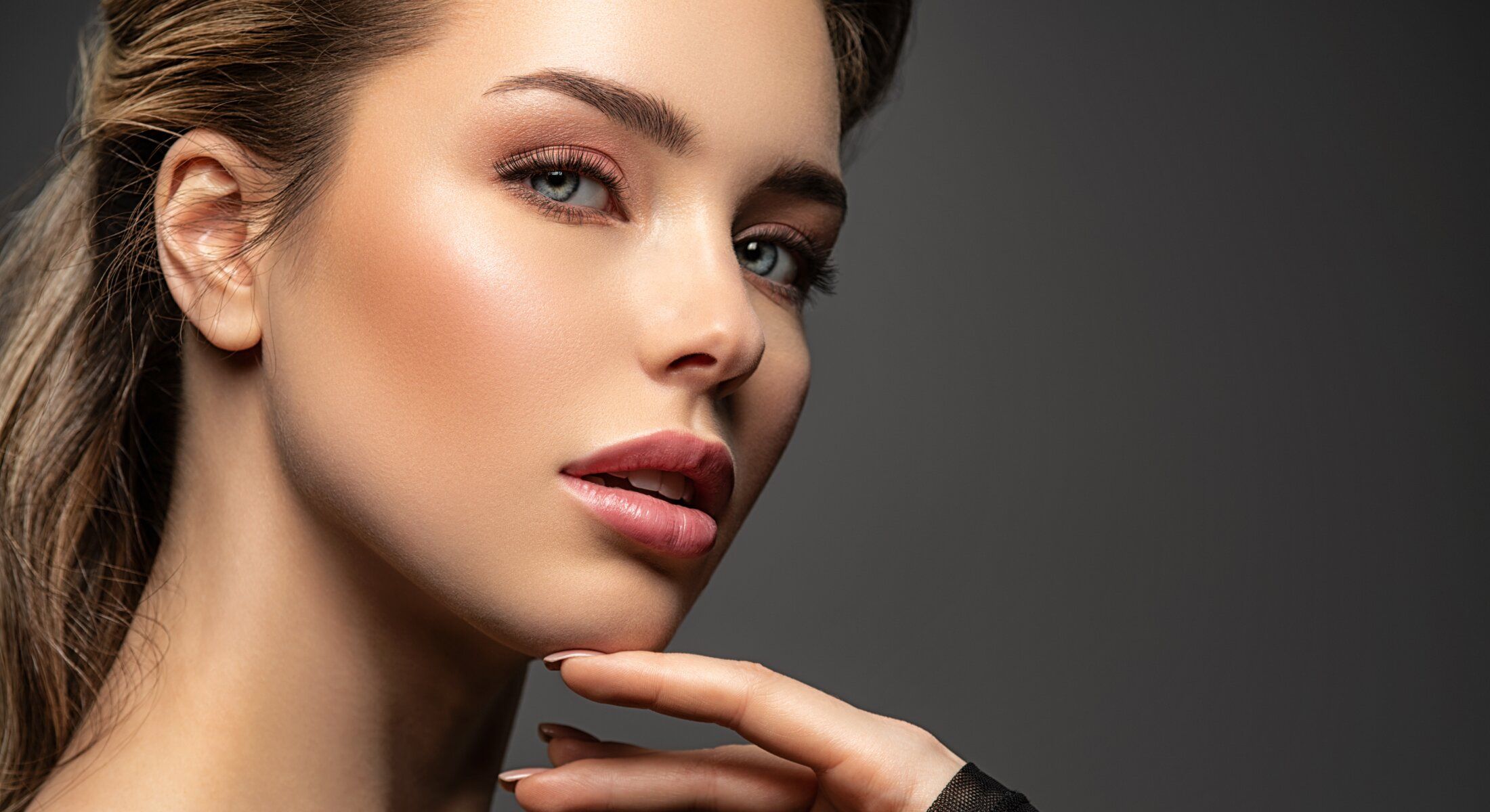 Close-up of a woman's face with soft lighting.