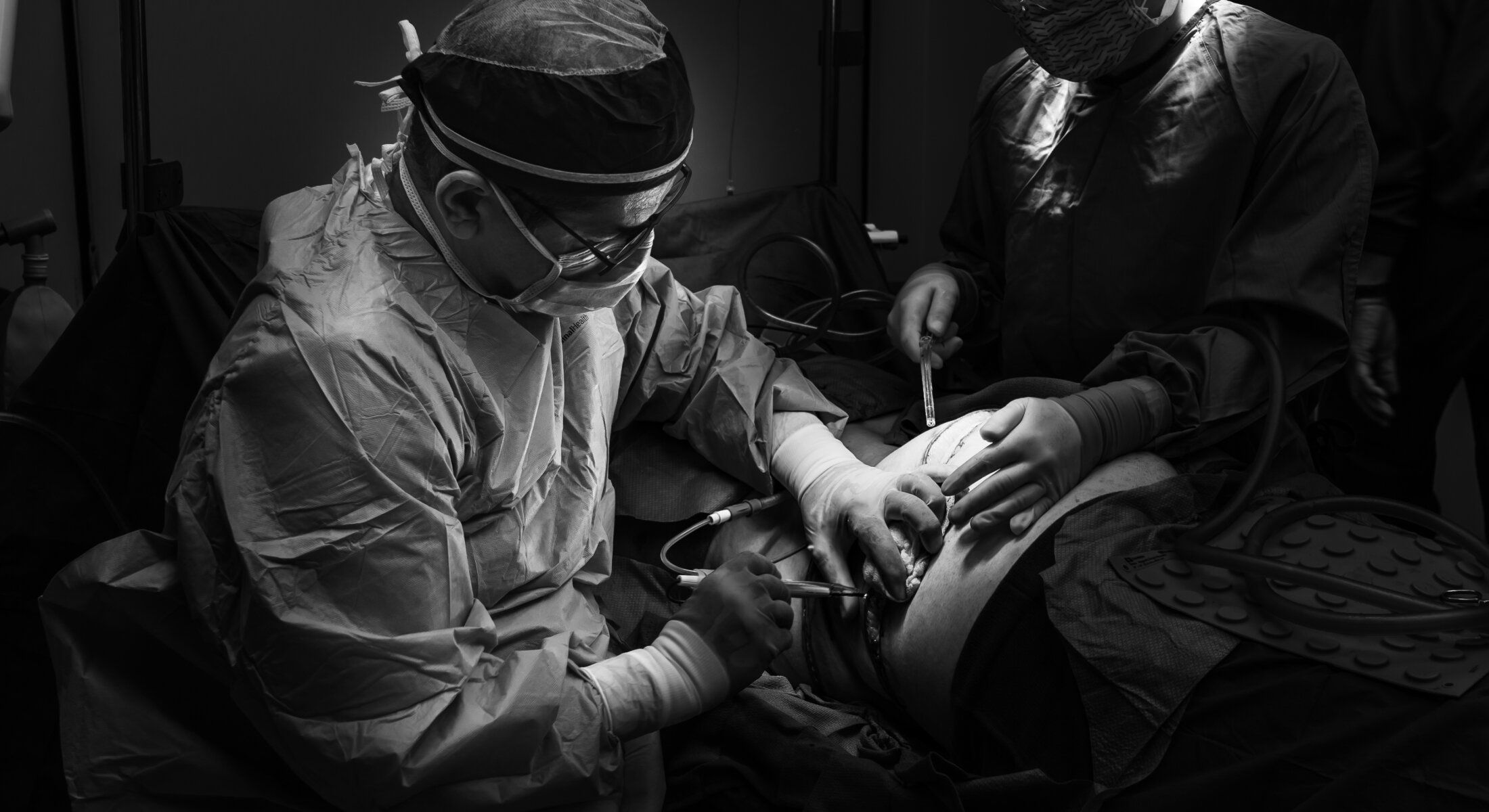 Surgeons performing a surgical procedure in operation room.