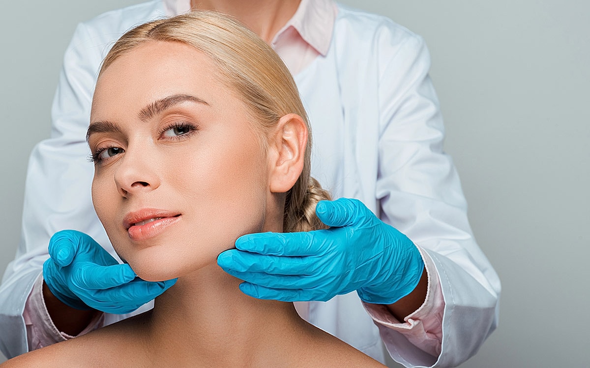 Professional skincare treatment with gloved hands.