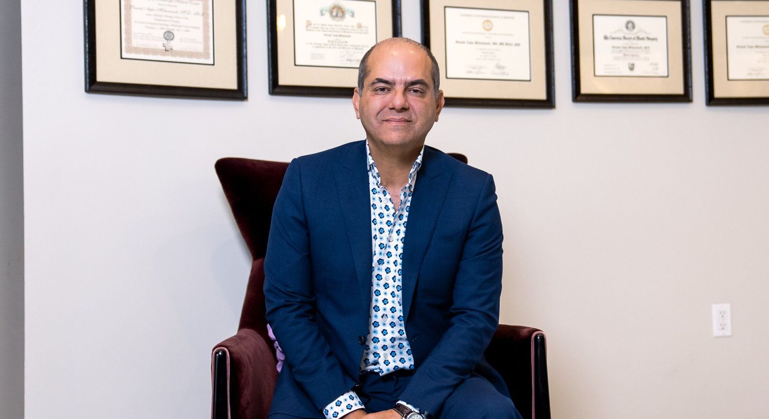 Professional man sitting in an elegant chair.